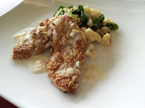 Pinhead oat crusted fish with lemon cream with roasted cauliflower and mustard greens